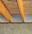SilverGlo™ insulation installed in a floor joist in Allegany
