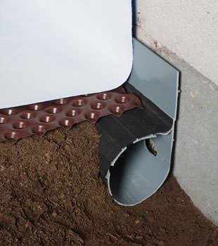 Closeup of a crawl space drainage system installed in Smethport
