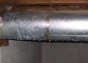 condensation collecting on an HVAC vent in a humid Allegany basement
