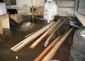 A severely flooding basement in Clearfield, with lumber and personal items floating in a foot of water