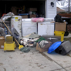Soaked, wet personal items sitting in a driveway, including a washer and dryer in Bradford.