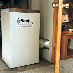 A basement dehumidifier with an ENERGY STAR® rating ducting dry air into a finished area of the basement  in Randolph