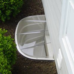 A vinyl basement window and covered window well in Franklinville