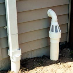A grated sump pump discharge line fitting in Emporium