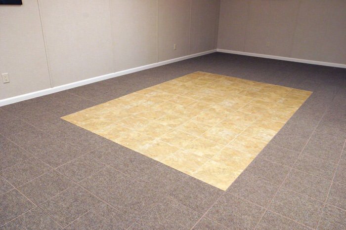 tiled and carpeted basement flooring installed in a Saint Marys home