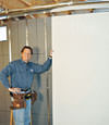 Installing wall panels on top of our basement wall insulation in Bradford